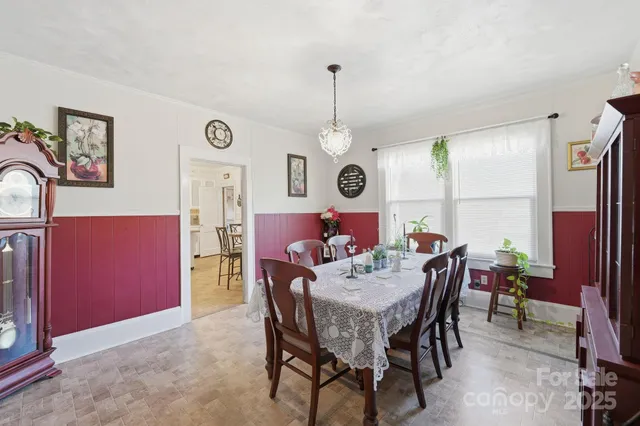 a view of a dining room with furniture and a chandelier