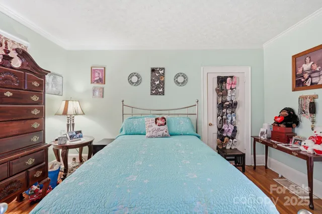 a bed room with a bed and wooden floor