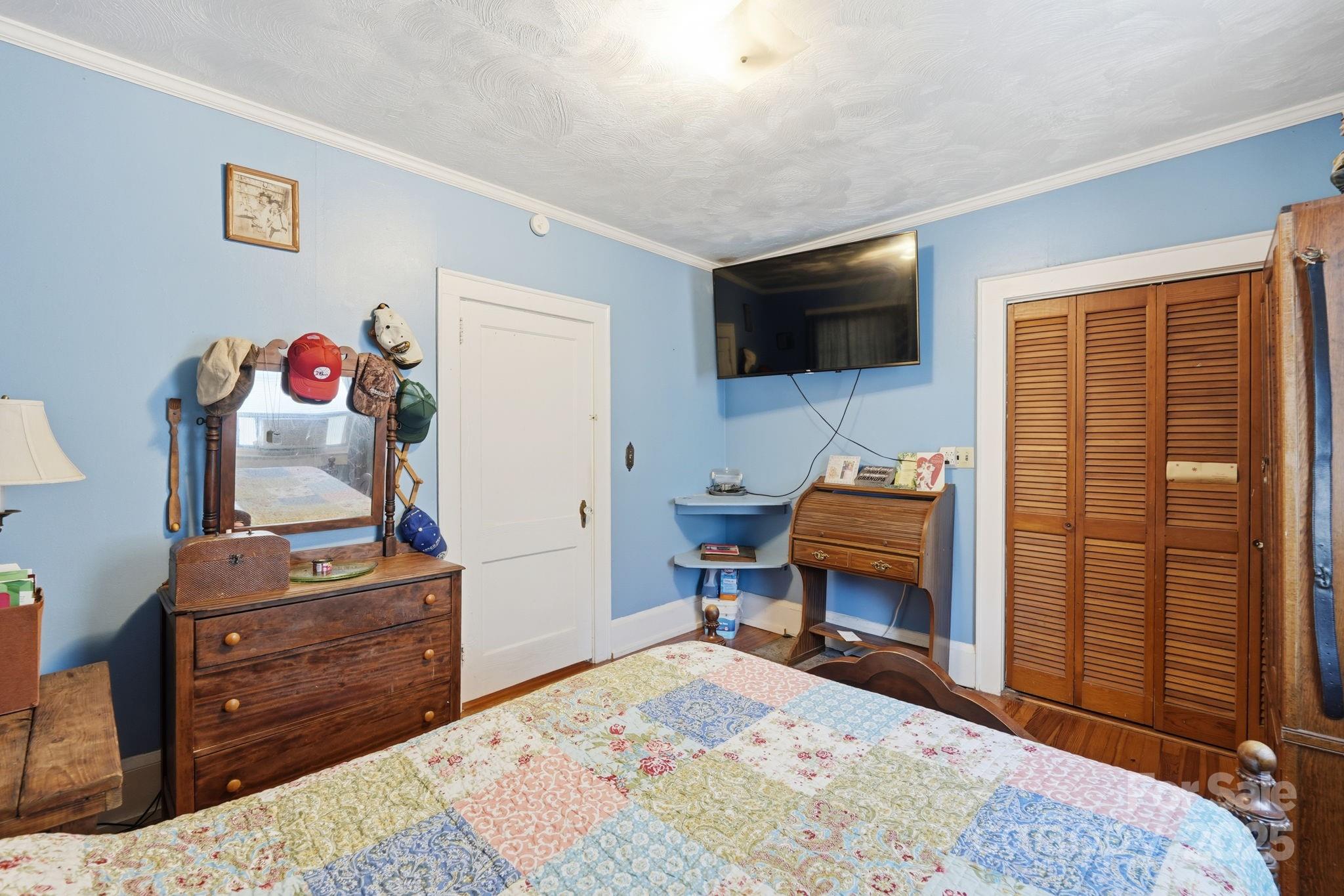 105 1st Street Rockingham, NC 28379 - Photo 18 of 28 a living room with furniture and a flat screen tv