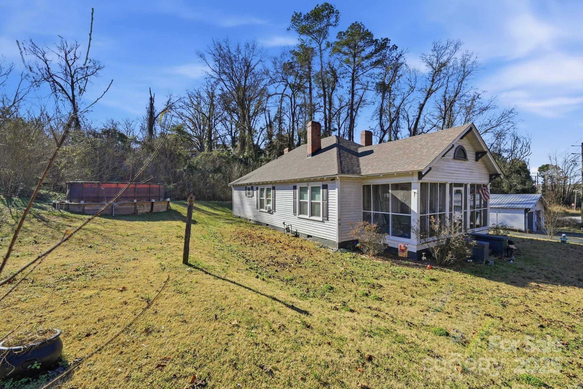 105 1st Street Rockingham, NC 28379 - Photo 2 of 28 a view of a house with a yard covered with snow in the backyard