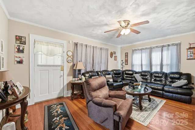 a living room with furniture a ceiling fan and a rug