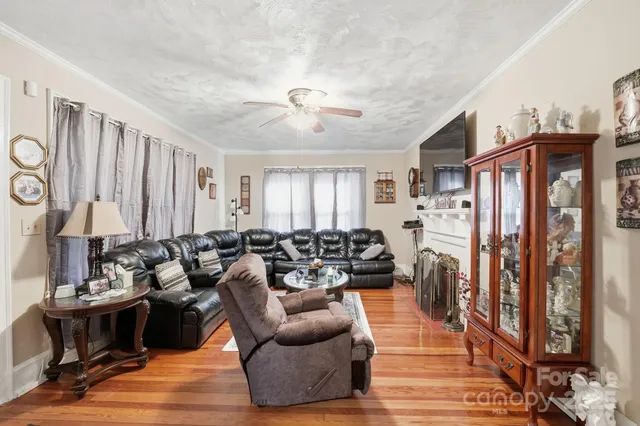a living room with furniture fireplace and a window