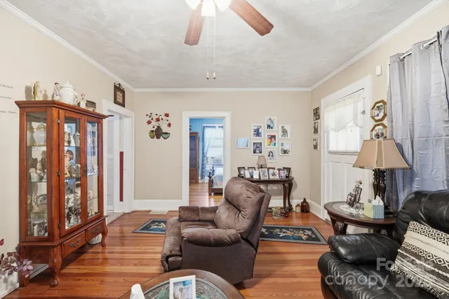 a living room with furniture a lamp and a window