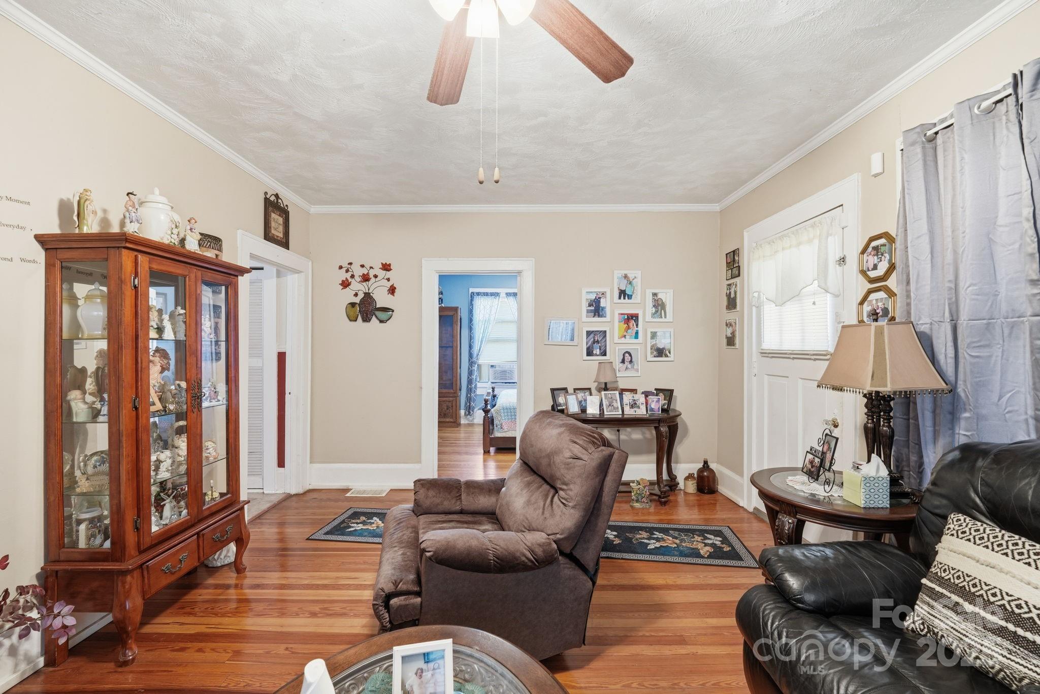 105 1st Street Rockingham, NC 28379 - Photo 7 of 28 a living room with furniture a lamp and a window