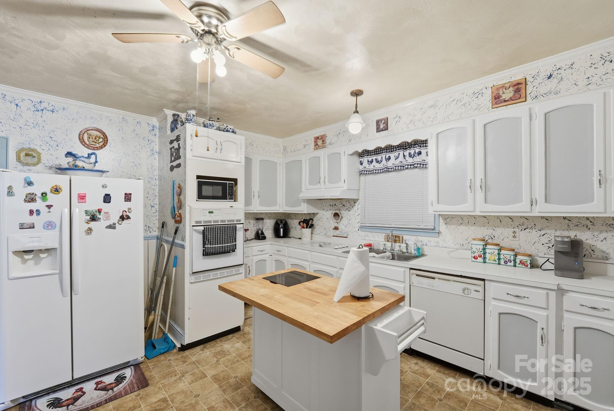 105 1st Street Rockingham, NC 28379 - Photo 9 of 28 a kitchen with stainless steel appliances granite countertop a sink stove and refrigerator