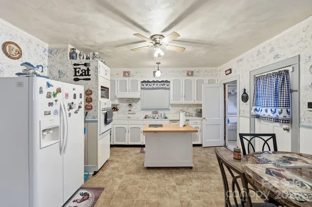 a kitchen with cabinets and refrigerator