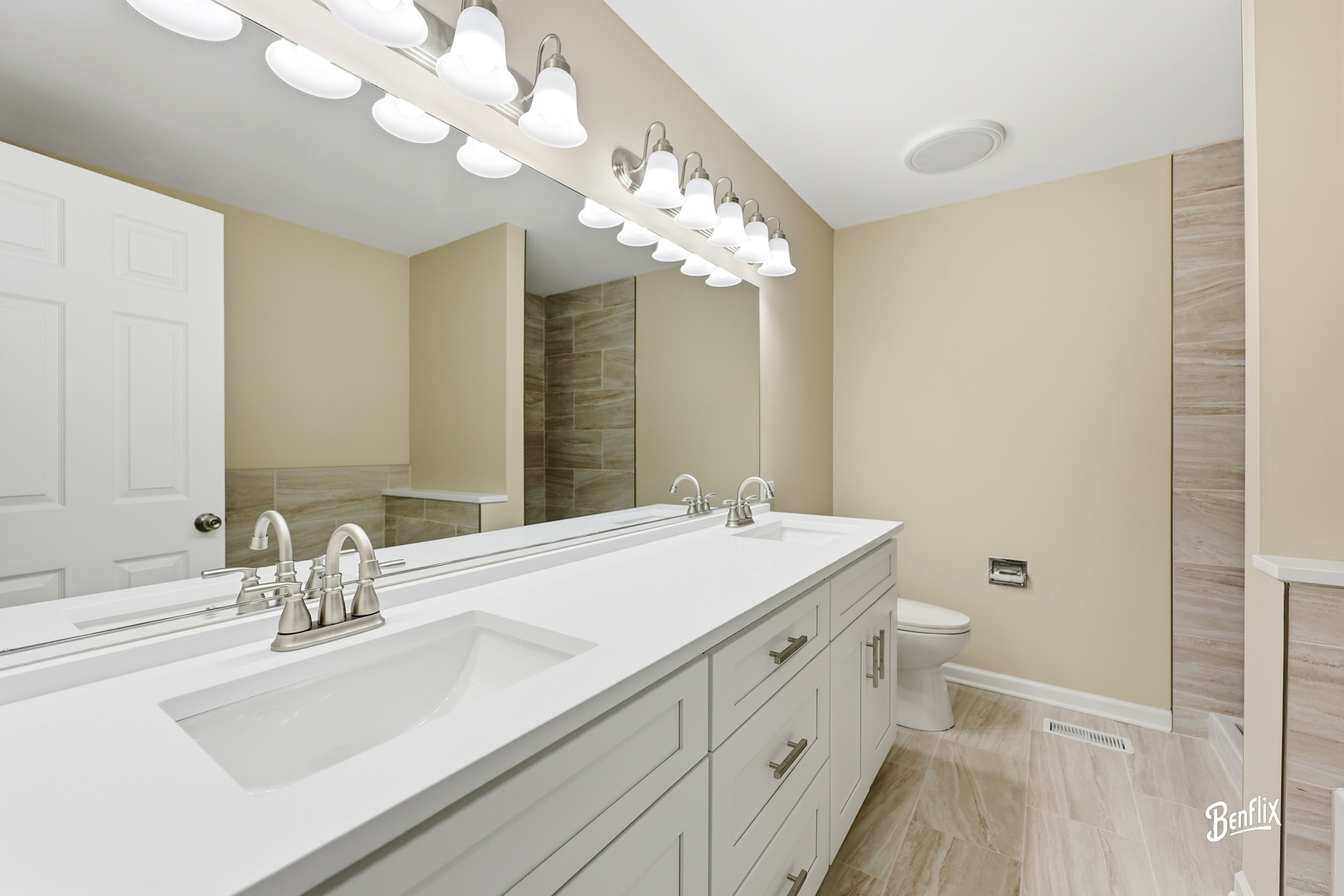 728 Old Checker Road Buffalo Grove, IL 60089 - Photo 13 of 22 a bathroom with a sink a large mirror and a toilet