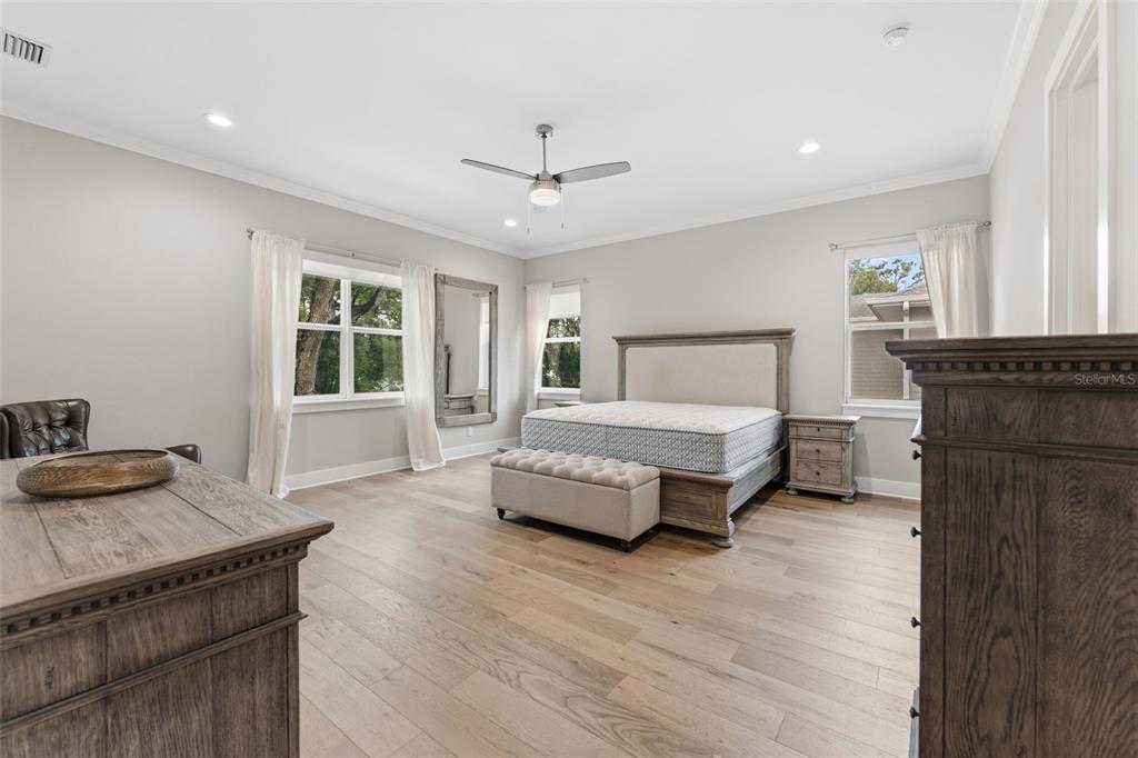 3314 West Villa Rosa Street Tampa, FL 33611 - Photo 15 of 55 a bedroom with a bed and a dresser with wooden floor