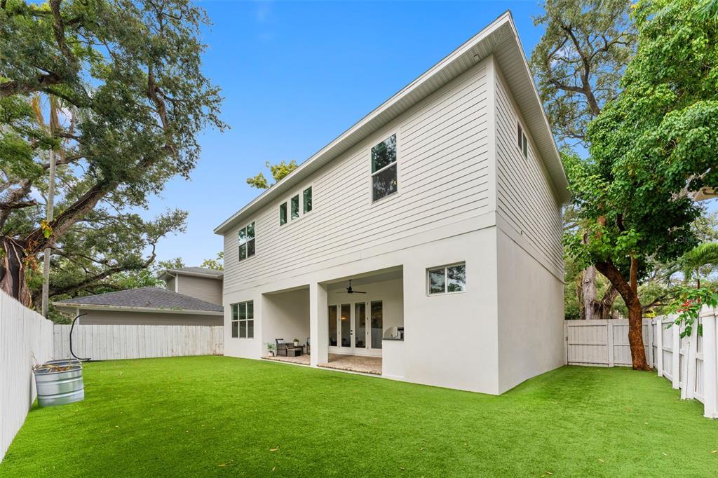 3314 West Villa Rosa Street Tampa, FL 33611 - Photo 40 of 55 a view of a white house next to a yard with a large tree