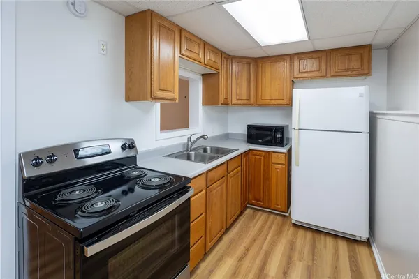 a kitchen with a stove a sink and a refrigerator