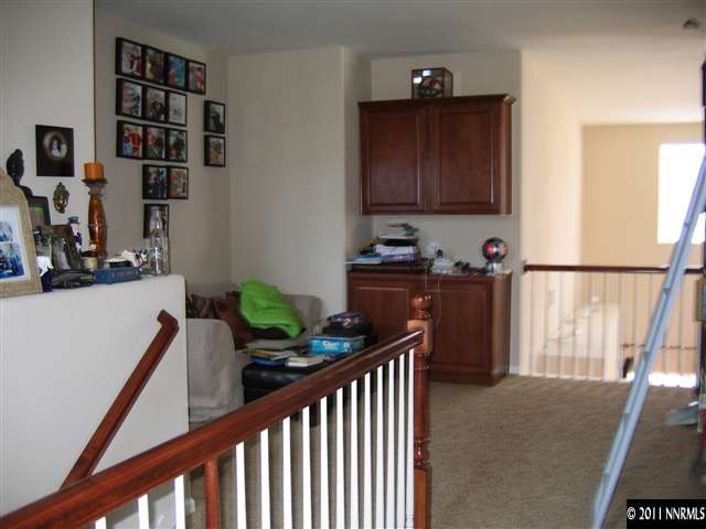 575 Little Sorrel Court Reno, NV 89521 - Photo 8 of 9 a view of a hallway to room with wooden floor and windows