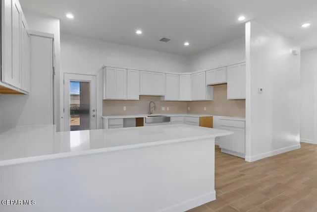 a utility room with cabinets washer and dryer