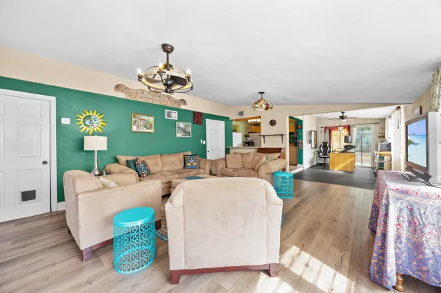 a living room with furniture and a chandelier