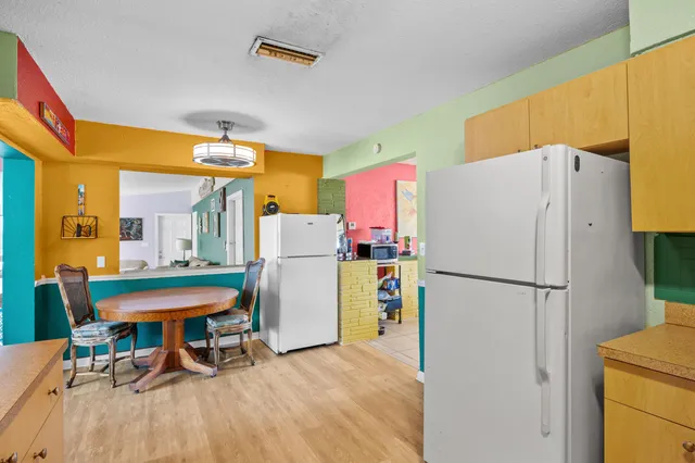 a white refrigerator freezer sitting in a kitchen