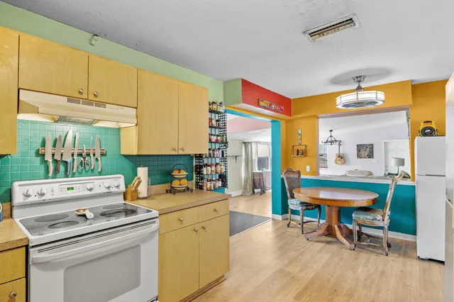 a view of a dining room with furniture and a chandelier
