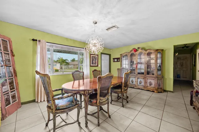 a view of a dining room and livingroom with furniture wooden floor and a rug
