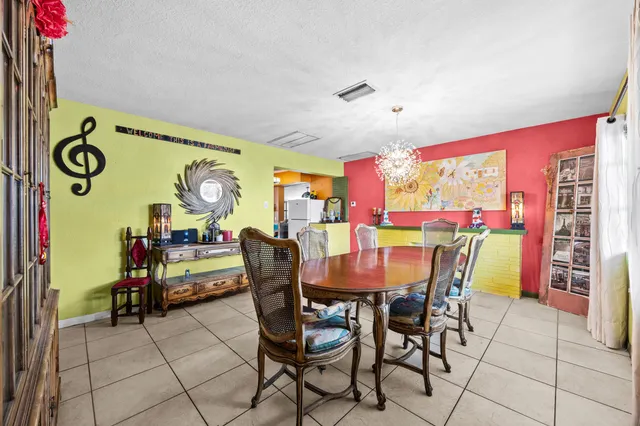 a view of a dining room with furniture and chandelier