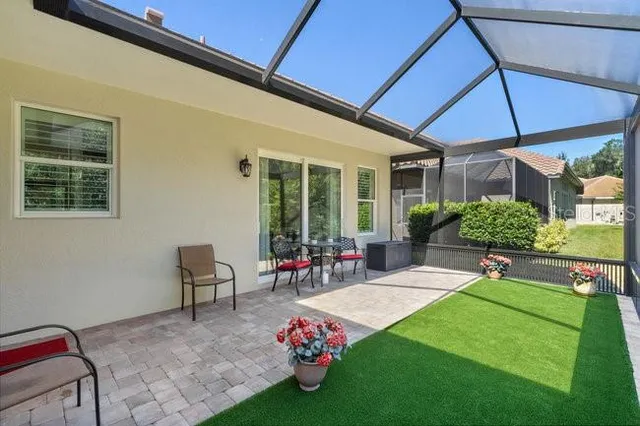 a view of a porch with furniture and garden