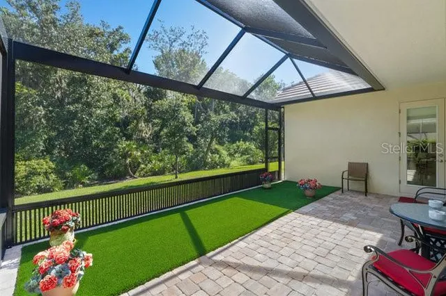 a living room with patio furniture and a ceiling fan