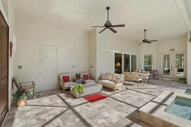 a living room with furniture and a chandelier