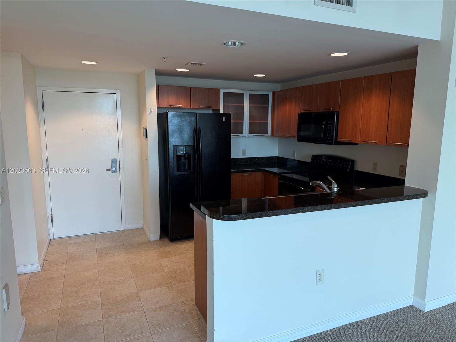 2021 Southwest 3rd Avenue, Unit 902 Miami, FL 33129 - Photo 3 of 14 a kitchen with a refrigerator and a sink