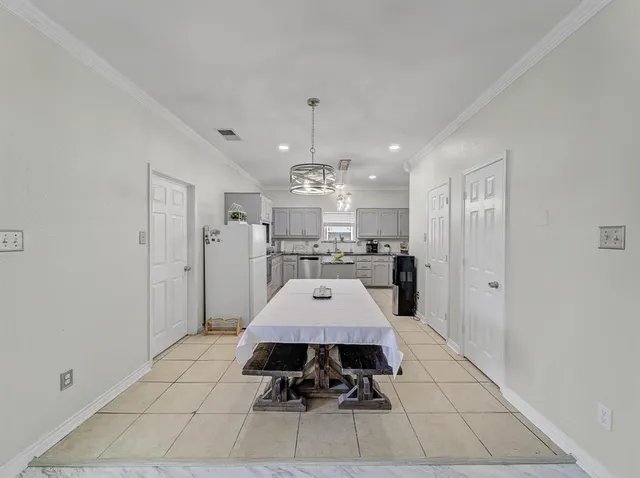 a large kitchen with a table and chairs