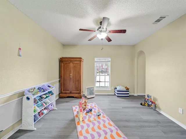 a bedroom with three beds and window