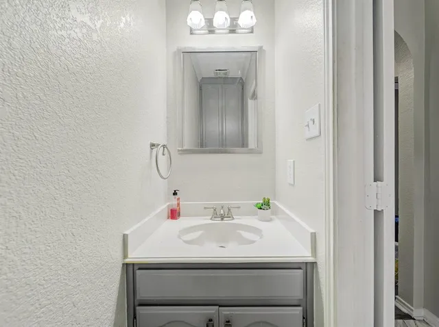a bathroom with a sink and a mirror