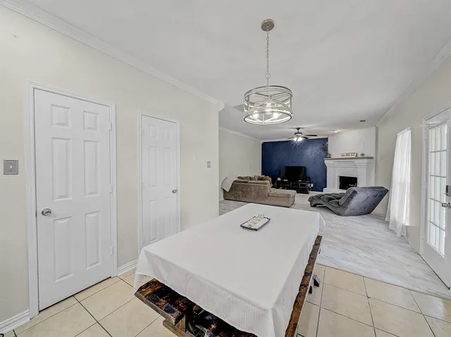 a view of a dining room with furniture a chandelier and wooden floor