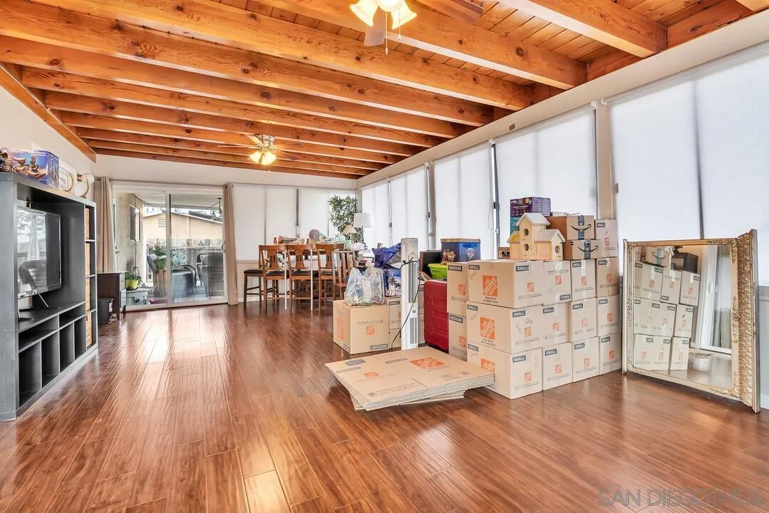 9677 Lutheran Way Santee, CA 92071 - Photo 14 of 33 a view of a hallway with wooden floor and chandelier