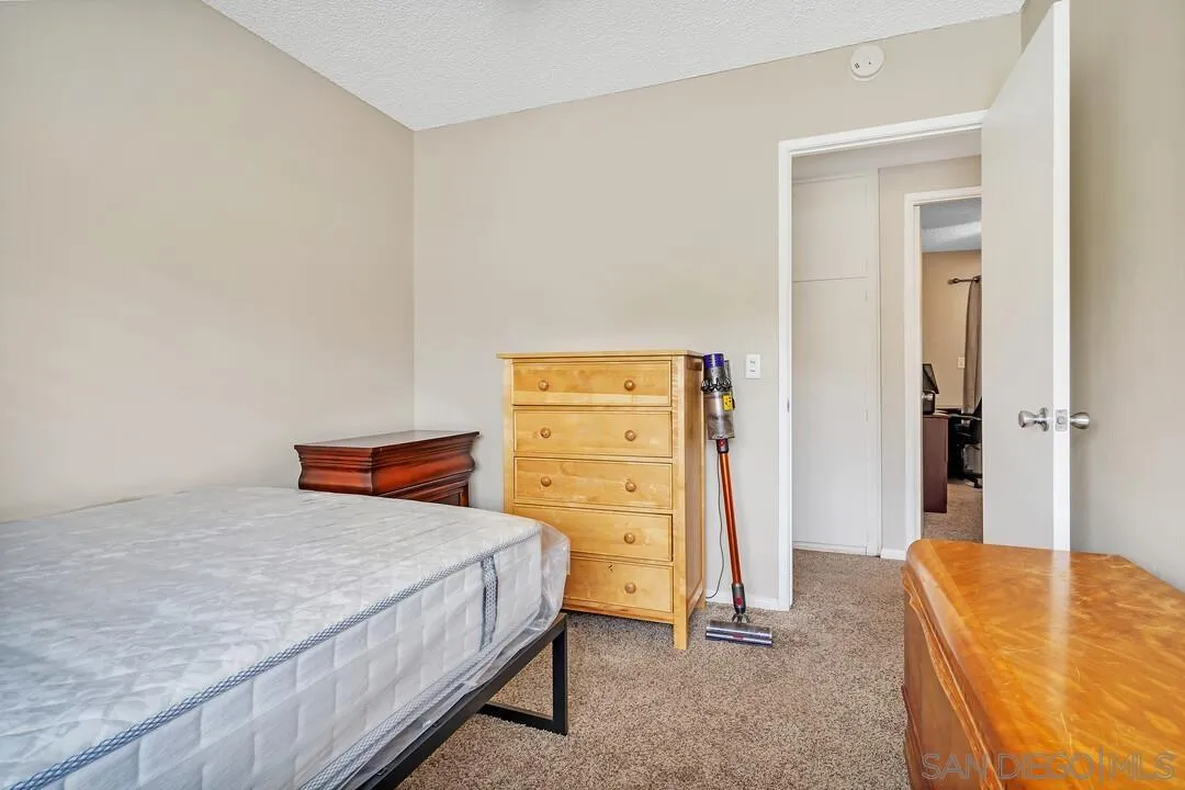9677 Lutheran Way Santee, CA 92071 - Photo 17 of 33 a bedroom with a bed and a furniture