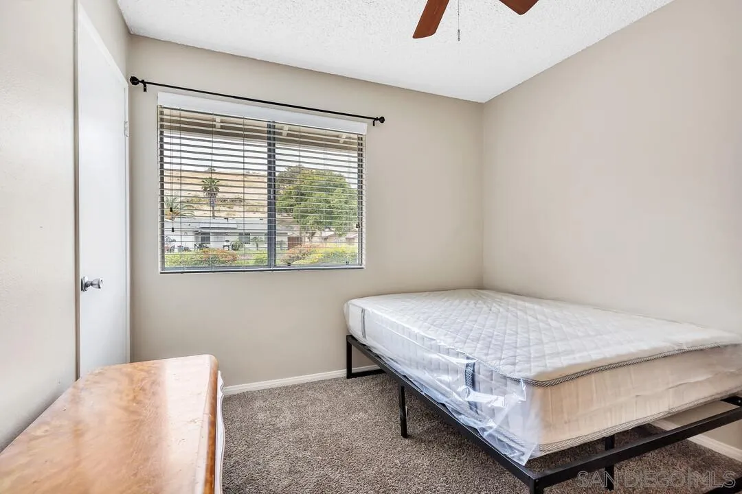 9677 Lutheran Way Santee, CA 92071 - Photo 18 of 33 a bedroom with a bed and window