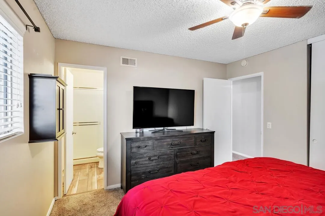 9677 Lutheran Way Santee, CA 92071 - Photo 19 of 33 a bedroom with a bed and a flat screen tv