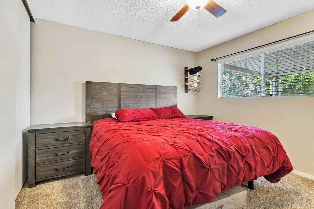 9677 Lutheran Way Santee, CA 92071 - Photo 20 of 33 a bed sitting in a bedroom next to a window