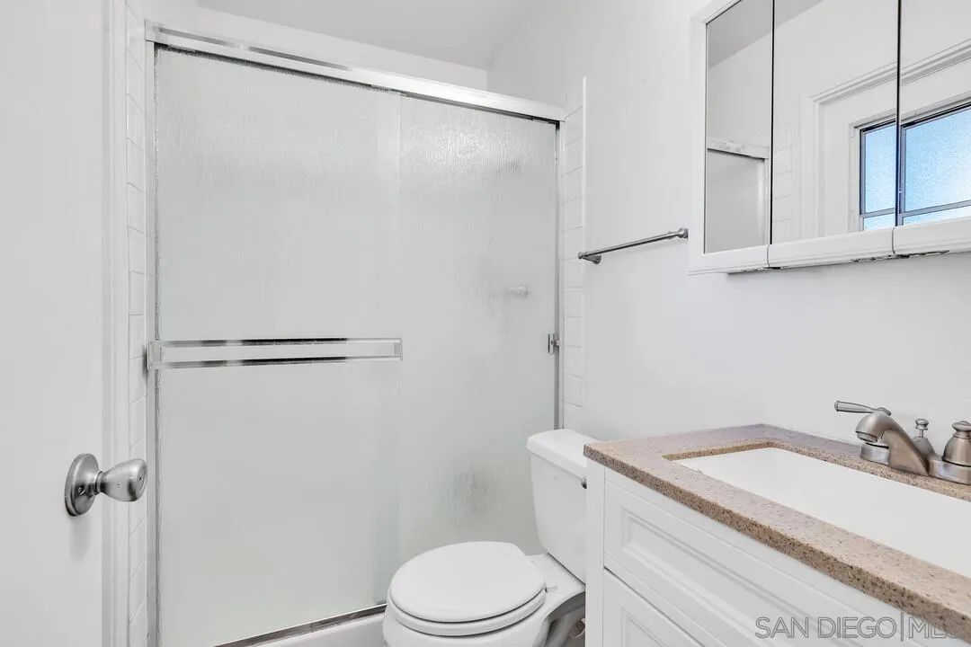 9677 Lutheran Way Santee, CA 92071 - Photo 21 of 33 a white toilet sitting next to a bathroom sink