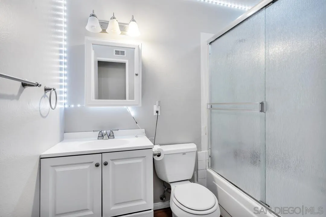 9677 Lutheran Way Santee, CA 92071 - Photo 24 of 33 a bathroom with a sink a toilet and shower