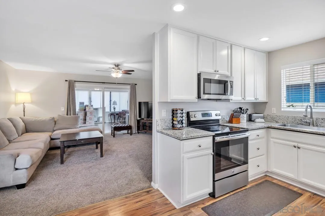9677 Lutheran Way Santee, CA 92071 - Photo 8 of 33 a view of living room kitchen with furniture and wooden floor