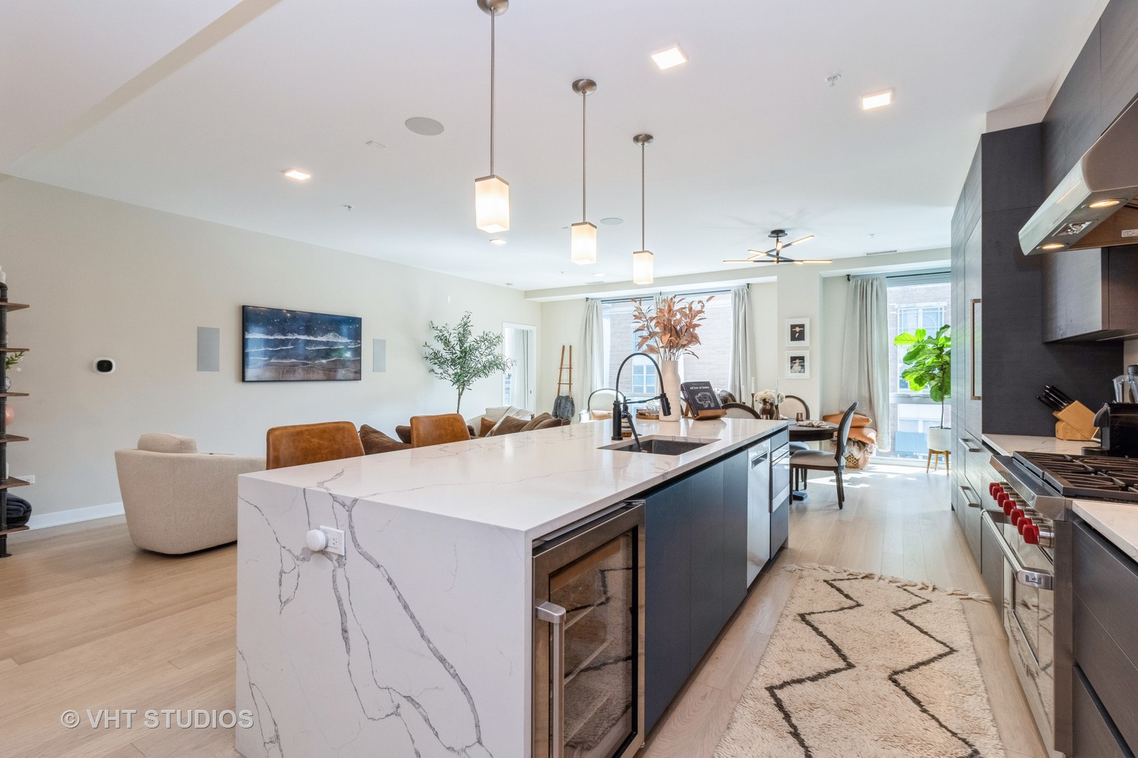1000 West Monroe Street, Unit 201 Chicago, IL 60607 - Photo 5 of 20 a large kitchen with stainless steel appliances a stove a sink a oven a table and chairs