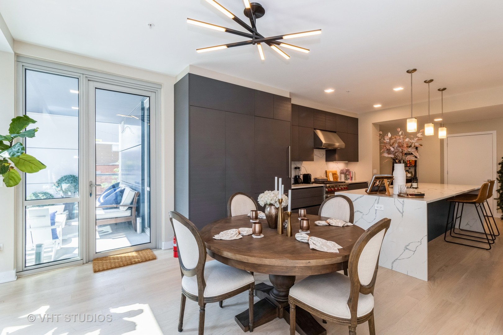 1000 West Monroe Street, Unit 201 Chicago, IL 60607 - Photo 9 of 20 a view of a dining room with furniture and a potted plant