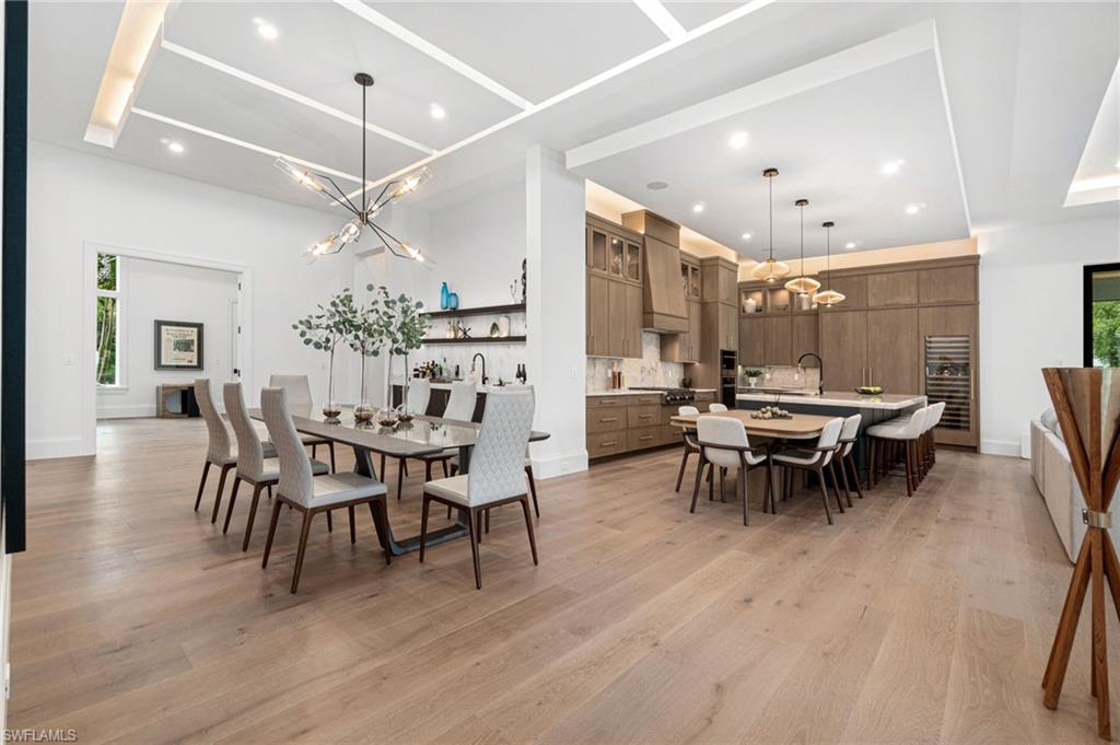 337 West Street Naples, FL 34108 - Photo 17 of 50 Dining space featuring light hardwood / wood-style floors, sink, and an inviting chandelier