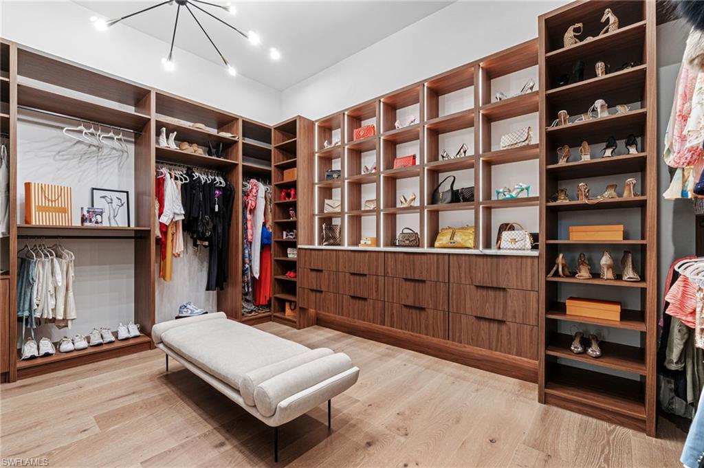 337 West Street Naples, FL 34108 - Photo 27 of 50 Spacious closet with light hardwood / wood-style floors and a notable chandelier