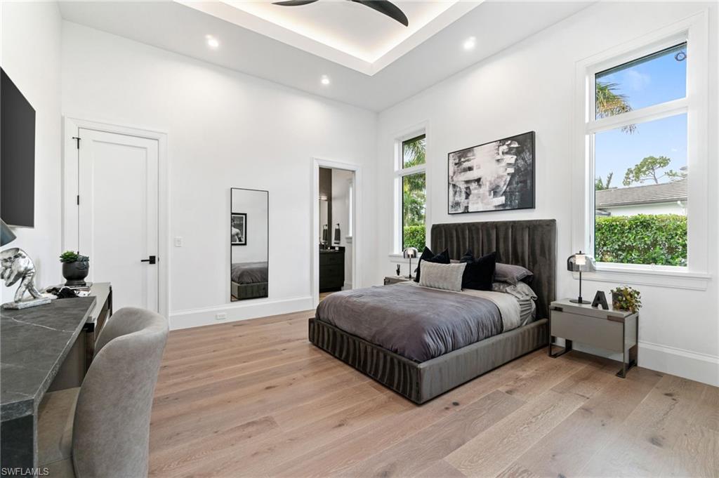 337 West Street Naples, FL 34108 - Photo 30 of 50 Bedroom with multiple windows, light wood-type flooring, and ceiling fan