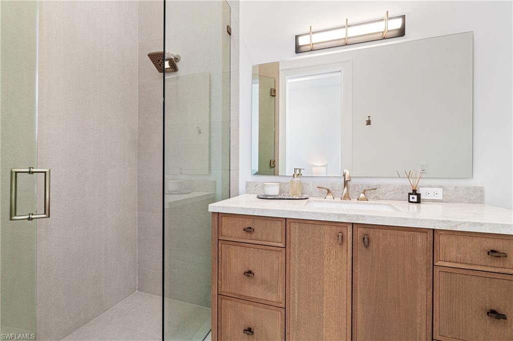 337 West Street Naples, FL 34108 - Photo 36 of 50 Bathroom featuring vanity and walk in shower