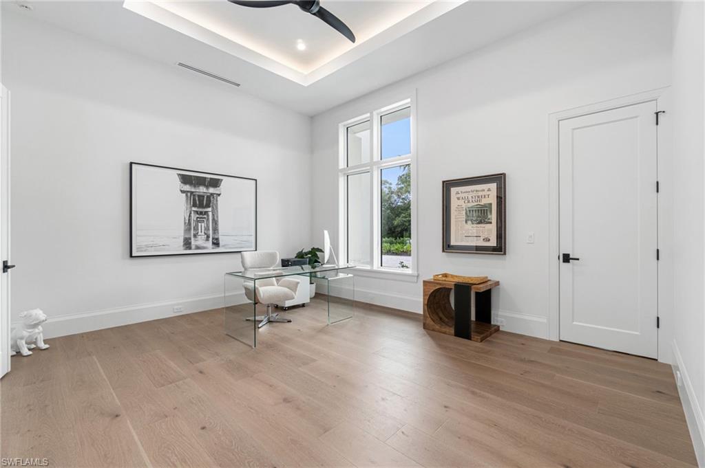 337 West Street Naples, FL 34108 - Photo 39 of 50 Unfurnished room with ceiling fan, light hardwood / wood-style flooring, and a raised ceiling