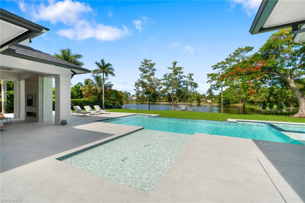 337 West Street Naples, FL 34108 - Photo 44 of 50 View of swimming pool featuring a water view and a patio