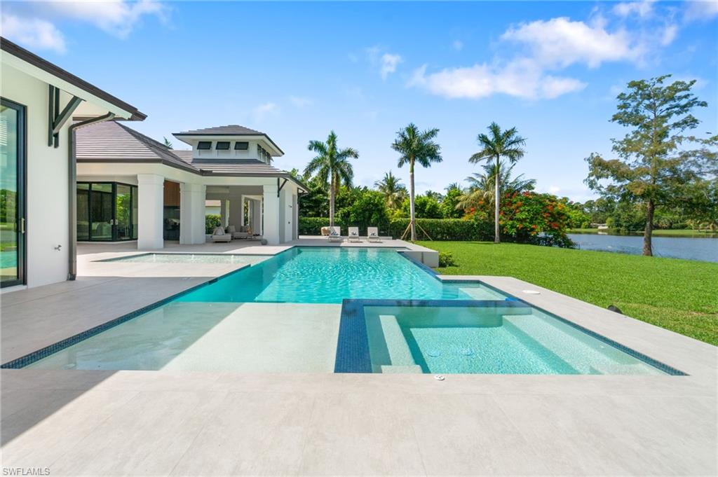 337 West Street Naples, FL 34108 - Photo 45 of 50 View of pool featuring a patio area and a yard