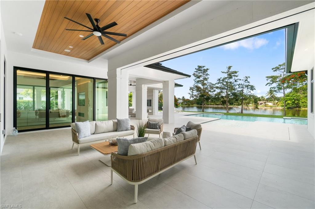337 West Street Naples, FL 34108 - Photo 46 of 50 View of patio / terrace featuring an outdoor living space, a water view, and ceiling fan