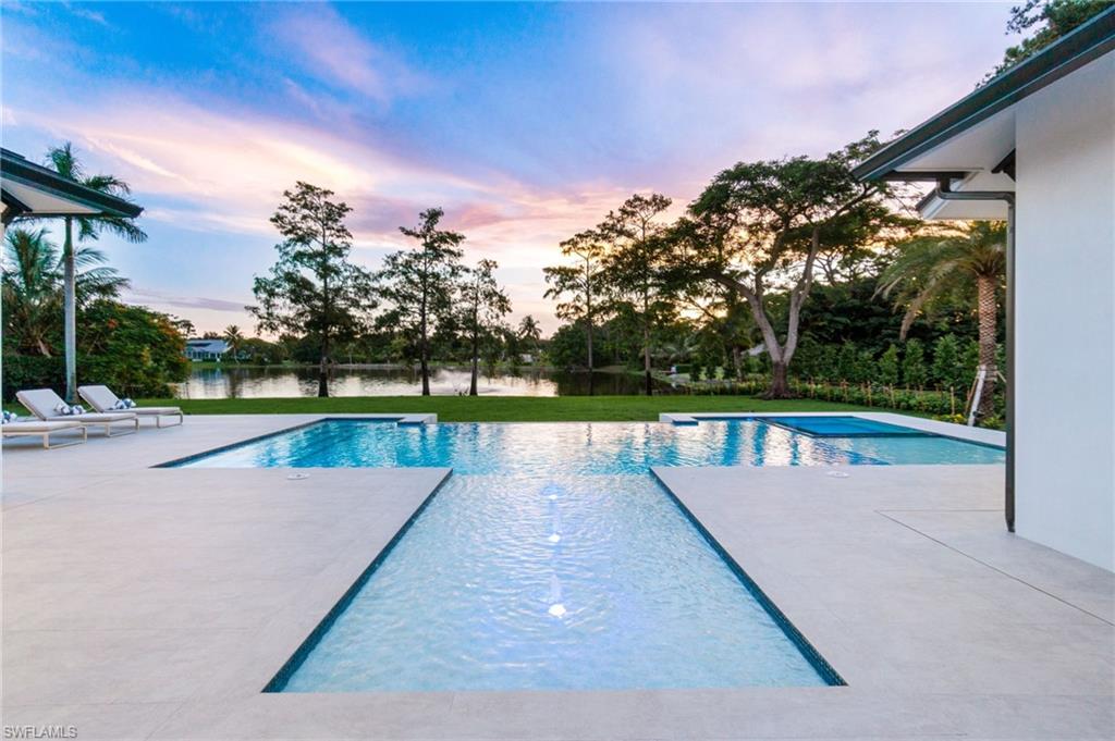 337 West Street Naples, FL 34108 - Photo 6 of 50 Pool at dusk with a patio