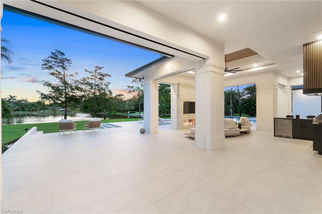 337 West Street Naples, FL 34108 - Photo 9 of 50 Patio terrace at dusk with a water view