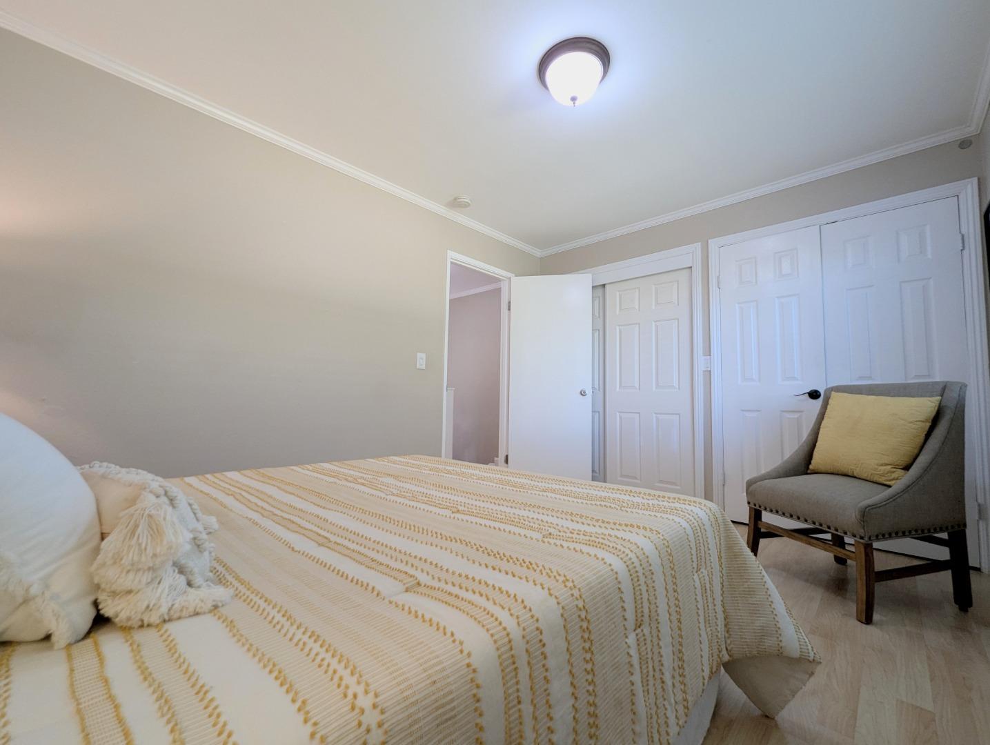 960 Kiely Boulevard, Unit F Santa Clara, CA 95051 - Photo 15 of 23 a bedroom with a bed and chair